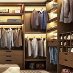 Large modern wardrobe with clothes with beautiful shelf lighting