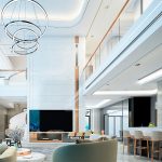 hotel lobby with chairs bar couch and large television showcasing l e d linear lighting