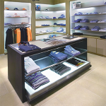 mens clothing store with shirts on shelf backlit with l e d light guide panels.