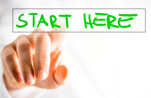 Hand pushing button that says Start Here